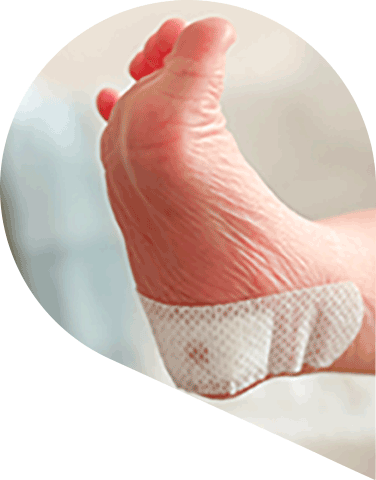 Infant foot with a spot of blood coming through a plaster on their heel