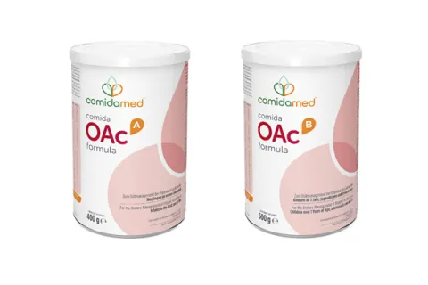Two cans, one of comida-OAc A formula, the other comida-OAc B formula